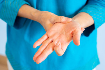 close up hands of old woman getting trigger finger from working