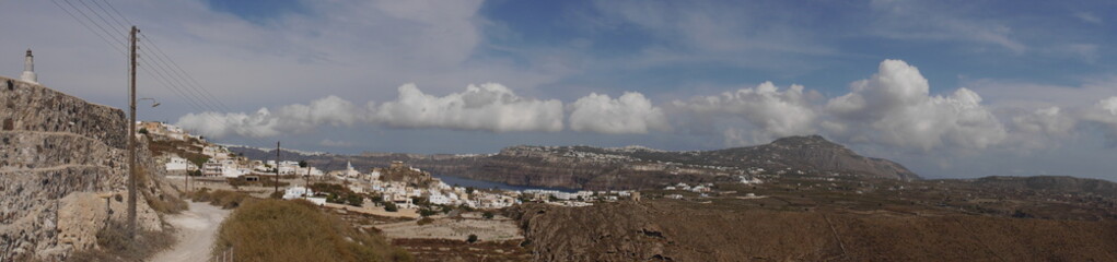 Panoramic view of the city of Akrotiri, an ancient ruined castle, caldera, and the Mediterranean Sea, on the island of Santorini Greece.