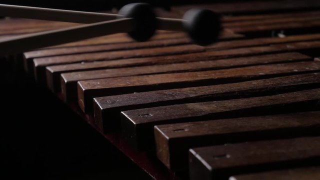 Close up of male musician hands take mallets and play xylophone or percussion instrument