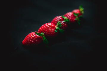 large strawberries on a black background
