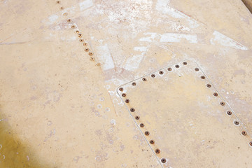 Detail of an old camouflage surface with exfoliated paint on a military aircraft. Fragment of a red star symbol of the Soviet Union air force. Military background