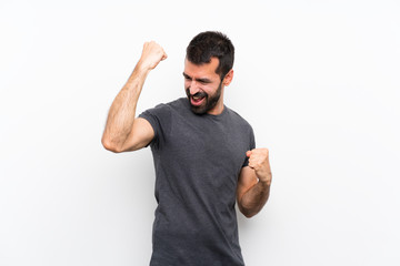 Fototapeta premium Young handsome man over isolated white background celebrating a victory