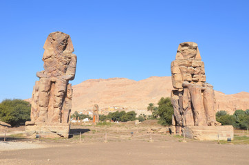 The Colossi of Memnon are two massive stone statues of the Pharaoh Amenhotep III, who reigned in Egypt during the Dynasty XVIII.