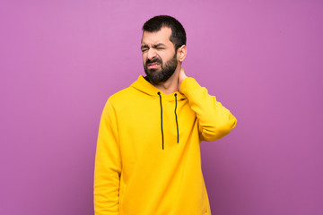 Handsome man with yellow sweatshirt with neckache