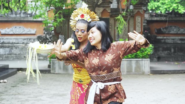 Balinese dancer teaching a tourist to dancing