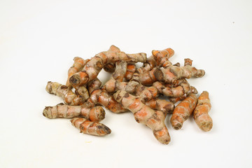 Turmeric root on a white background is used as a tonic for the body and food ingredients.