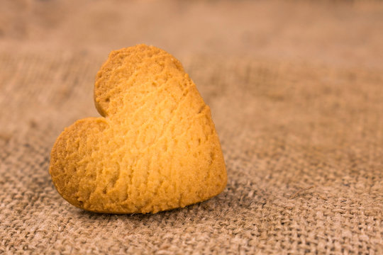 One heart-shaped cookie. Close-up. Copy space.