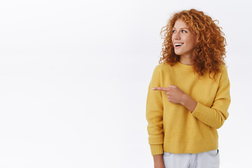 Amused, attractive redhead tender curly girl in white sweater, attend party, see friends and...