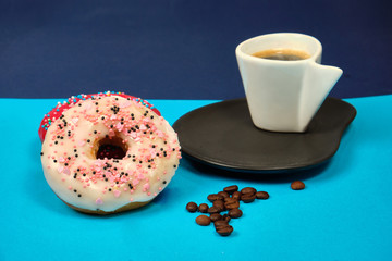 doughnuts and a Cup of coffee on a blue background, space for text