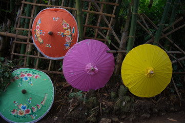 Colorful tribute style umbrella on a bamboo wall