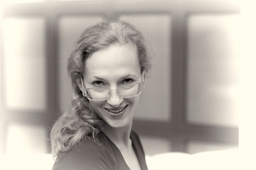 Portrait of a smiling pretty young business woman wearing glasse