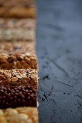 Row of mixed gluten free granola cereal energy bars. With dried fruits and nuts.