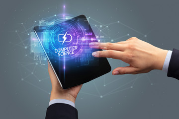Businessman holding a foldable smartphone with ENERGY inscription, new technology concept COMPUTER SCIENCE
