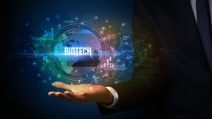 Elegant hand holding BIOTECH inscription, digital technology concept