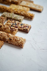 Row of mixed gluten free granola cereal energy bars. With dried fruits and nuts.
