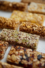 Close up on healthy granola fit bars arragement. Placed on white table