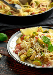 Homemade Brussels sprouts, bacon, pancetta pasta with parmesan cheese. On wooden table