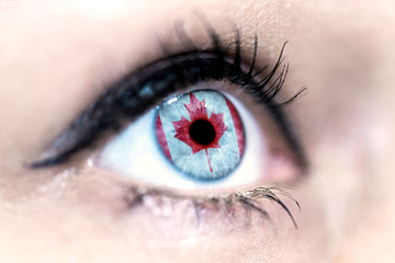 Flag of Canada reflects in a woman blue eye - election, sport, hope, young, generation, pride, dream, emotion, independance	