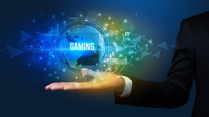 Elegant hand holding GAMING inscription, digital technology concept