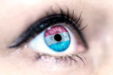 Flag of luxembourg reflects in a woman blue eye - election, sport, hope, young, generation, pride, dream, emotion, independance	