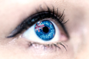 Flag of New Zealand reflects in a woman blue eye - election, sport, hope, young, generation, pride, dream, emotion, independance	