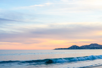 Set of pictures of a fantastic ocean wave in different stages. Cloudy sunrise sky. San Jose del...
