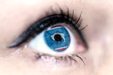 Flag of Wyoming state of the United States of America reflects in a woman blue eye - election, sport, hope, young, generation, american football, basket, emotion