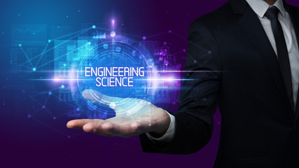 Man hand holding ENGINEERING SCIENCE inscription, technology concept