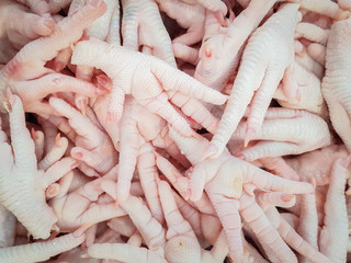 Many Chicken feet for sale in fresh market , Food , Spicy soup , raw material