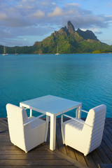 Table and chairs with a view of the Mont Otemanu and the Bora Bora lagoon in French Polynesia