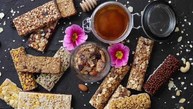 Healthy superfood composition. Various kinds granola energy protein bars with honey in jar