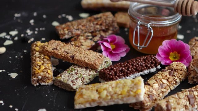 Healthy superfood composition. Various kinds granola energy protein bars with honey in jar