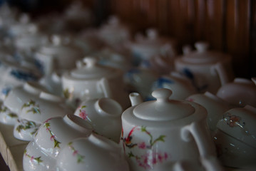 White porcelain tea cup pile with bubble blur background