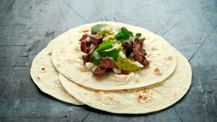 Carne Asada Tacos with grilled steak, green sauce and onion. Mexican food