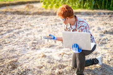Smart agriculture. Young Farmer using tablet corn planting. Modern Agriculture concept.