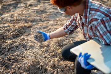 Close-up Smart agriculture. Young Farmer using tablet corn planting. Modern Agriculture concept.
