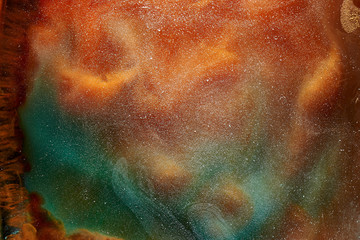 Vibrant colors of outer space ocean pattern abstract background. Mixing paint and liquid smoke, colorful splash and swirl of drops, underwater mystical backdrop