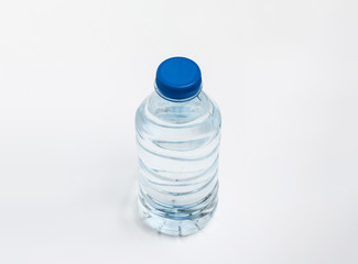 Plastic bottle of still healthy water isolated on white background. Small water bottle.