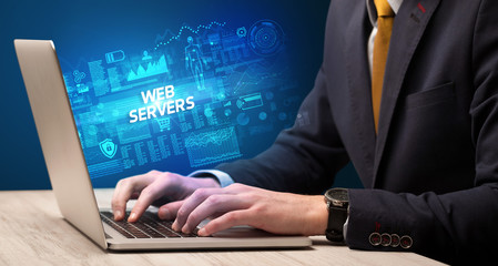 Fototapeta na wymiar Businessman working on laptop with WEB SERVERS inscription, cyber technology concept