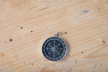 Compass on wooden table