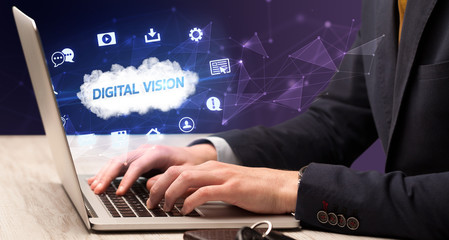 Businessman working on laptop with DIGITAL VISION inscription, modern technology concept