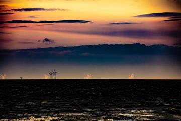 sunset at sea wind power