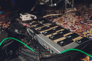 Electric guitar and guitar audio processing effects on a studio floor. Electric guitar and stomp...