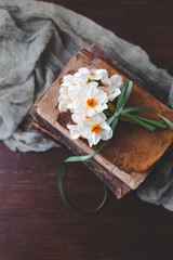 Small Bouquet of Paperwhite Nacissus tied with Green Ribbon on Vintage Books