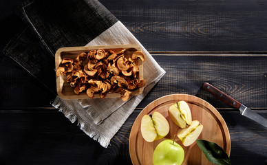dried and fresh apples on a wooden table in morning light