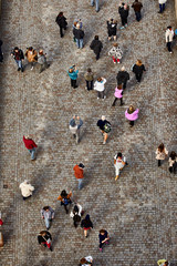 People walk across the Charles Bridge in Prague, top view
