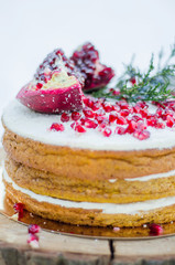 Handmade brown biscuit cake decorated with garnet with cream