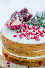 Handmade brown biscuit cake decorated with garnet with cream