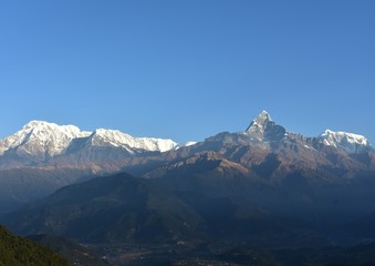 peak of fistail mountain with snow mountain in blue sky