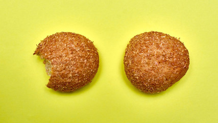 Natural homemade bread isolated on a yellow background.